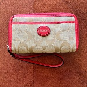 Coach wristlet in beige signature C’s with pink accents and interior